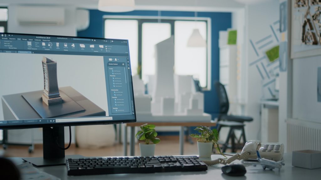 Close up of 3d building model on computer screen in empty office for architectural design